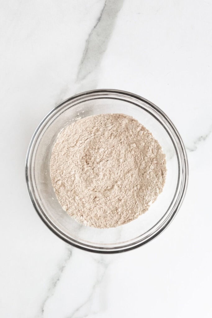 Sifted dry ingredients mixed together in a glass bowl