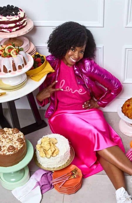 Jocelyn sitting with lots of cakes