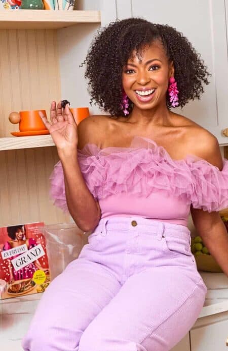 Jocelyn in pink sitting on couter smiling