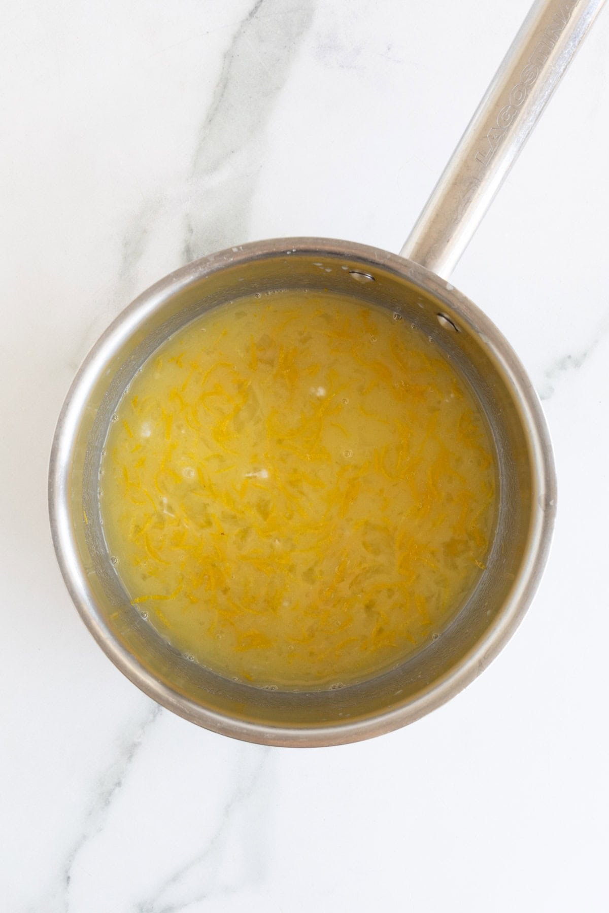 Lemon curd mixture beginning to warm in the saucepan