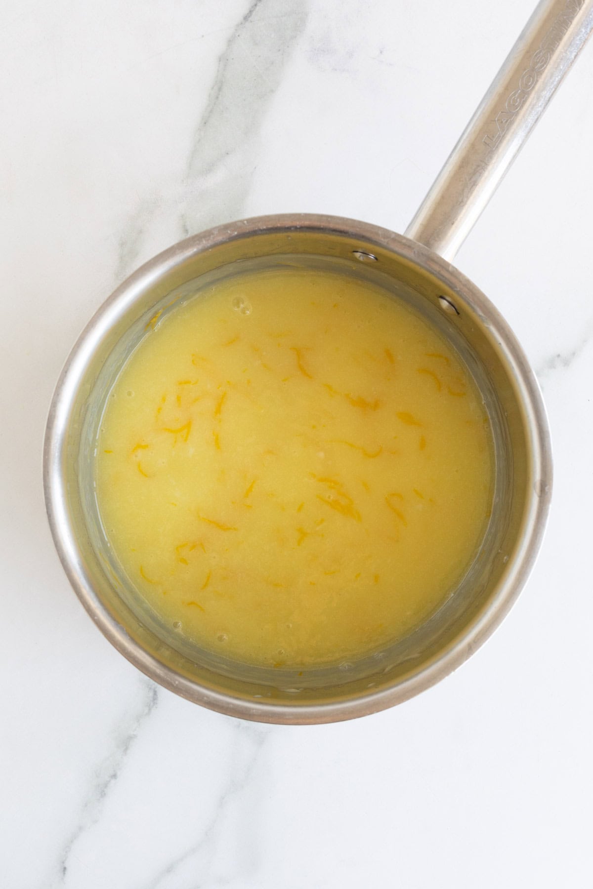 Lemon curd thickening as it cooks in the saucepan