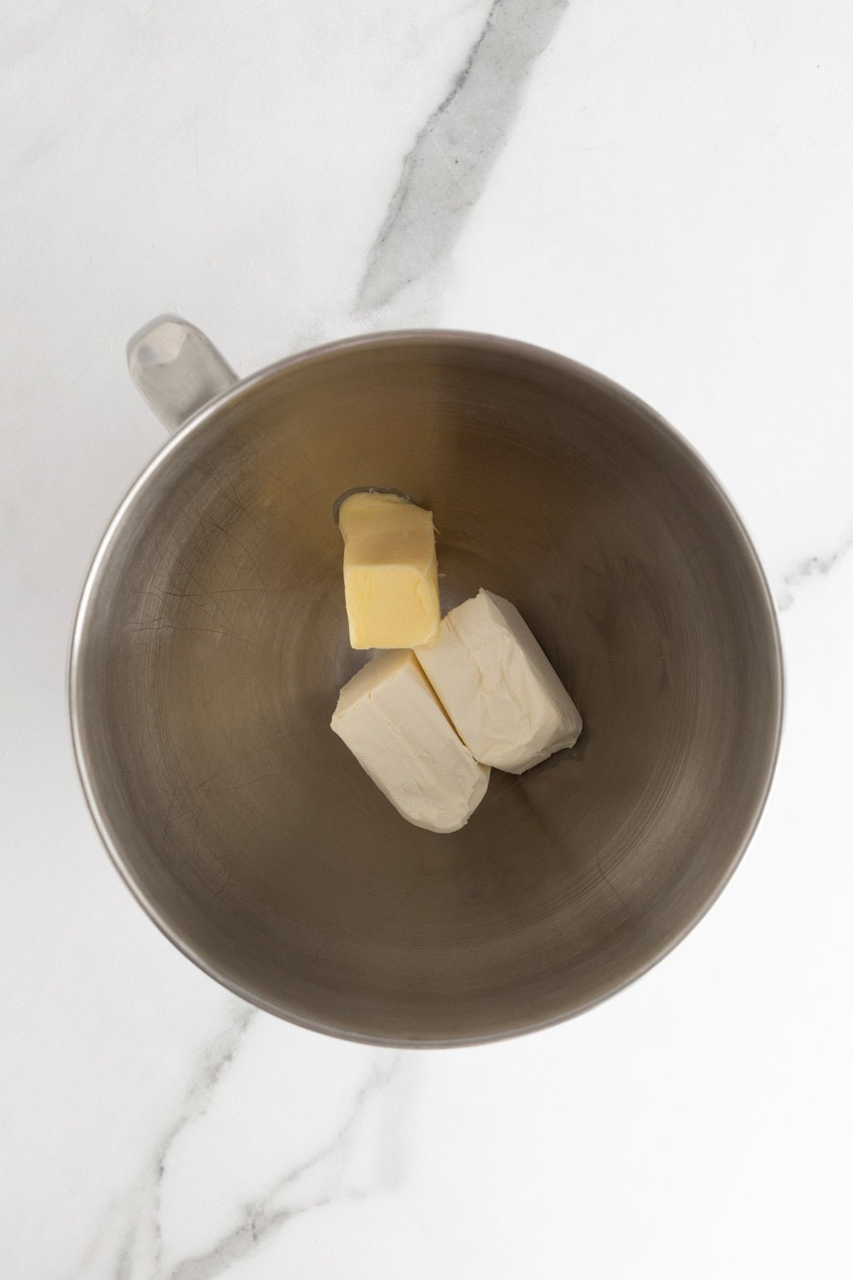 Butter and cream cheese placed in a mixing bowl