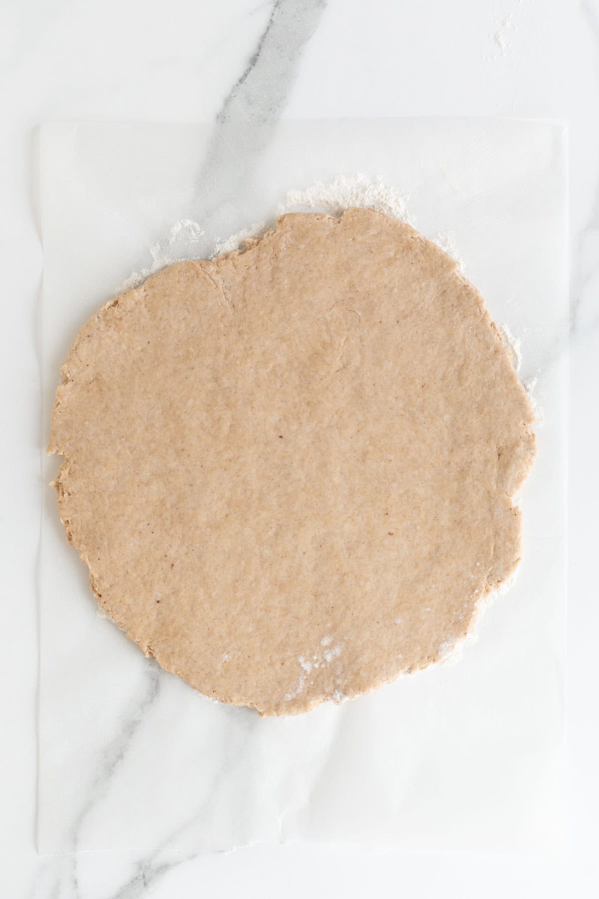 Rolled out dough on a floured surface, ready to be cut