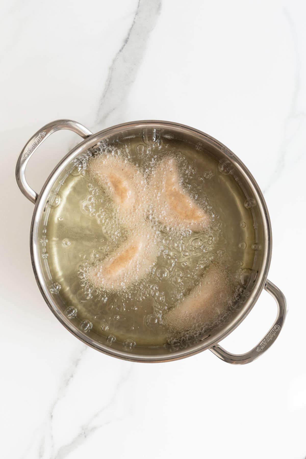 Hand pies frying in bubbling oil