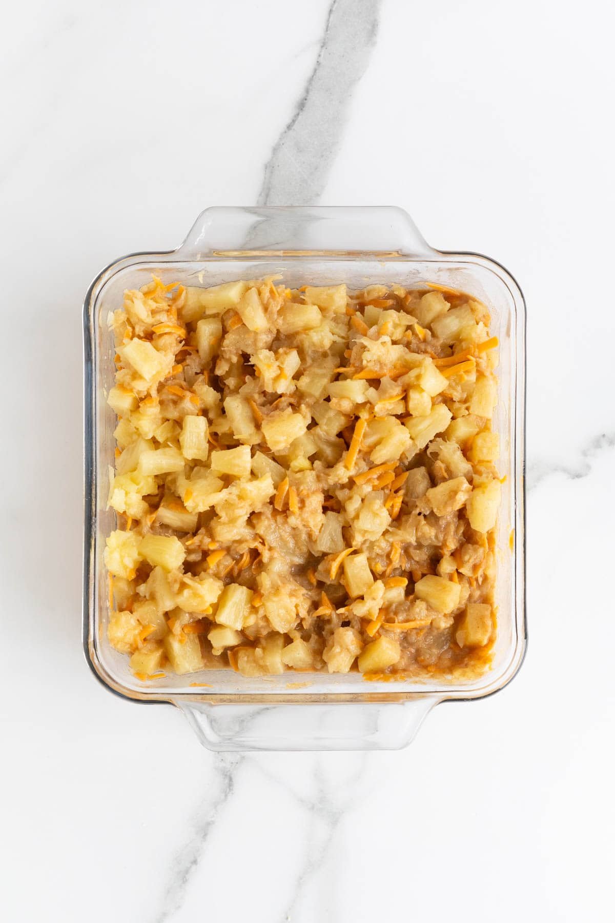 Pineapple and cheese mixed evenly into the casserole base