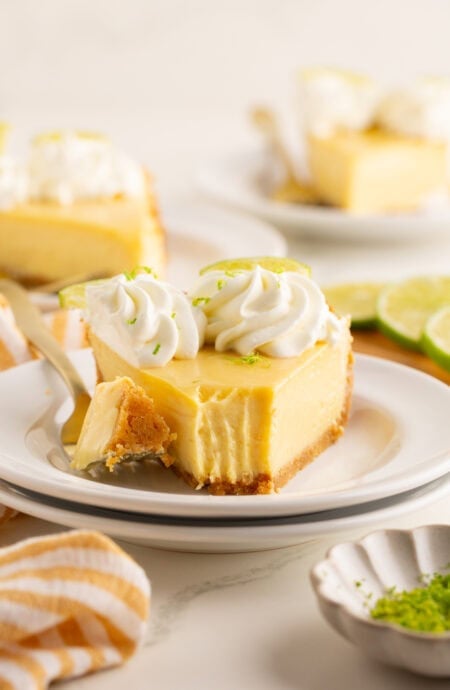 A slice of key lime pie on a plate with a fork.