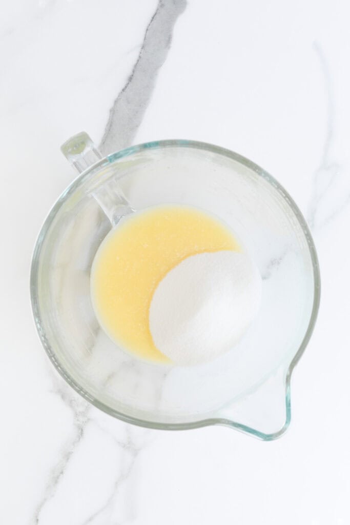 Sugar added to whipped butter and oil in stand mixer bowl