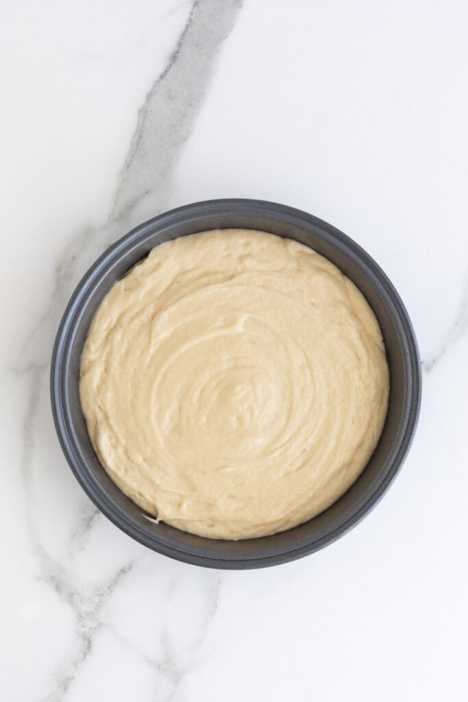 vanilla cake recipe batter added to a pan before baking