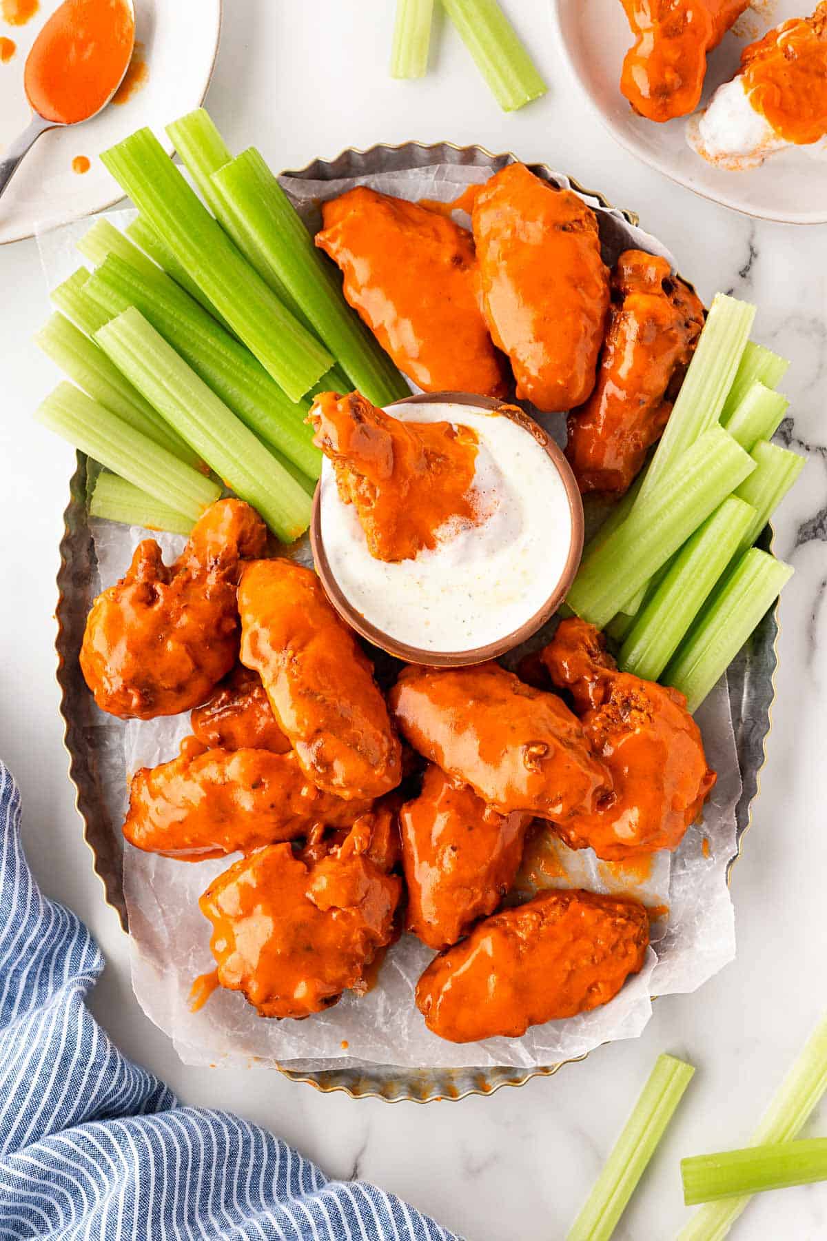 Overhead view of buffalo wings platter with celery and ranch