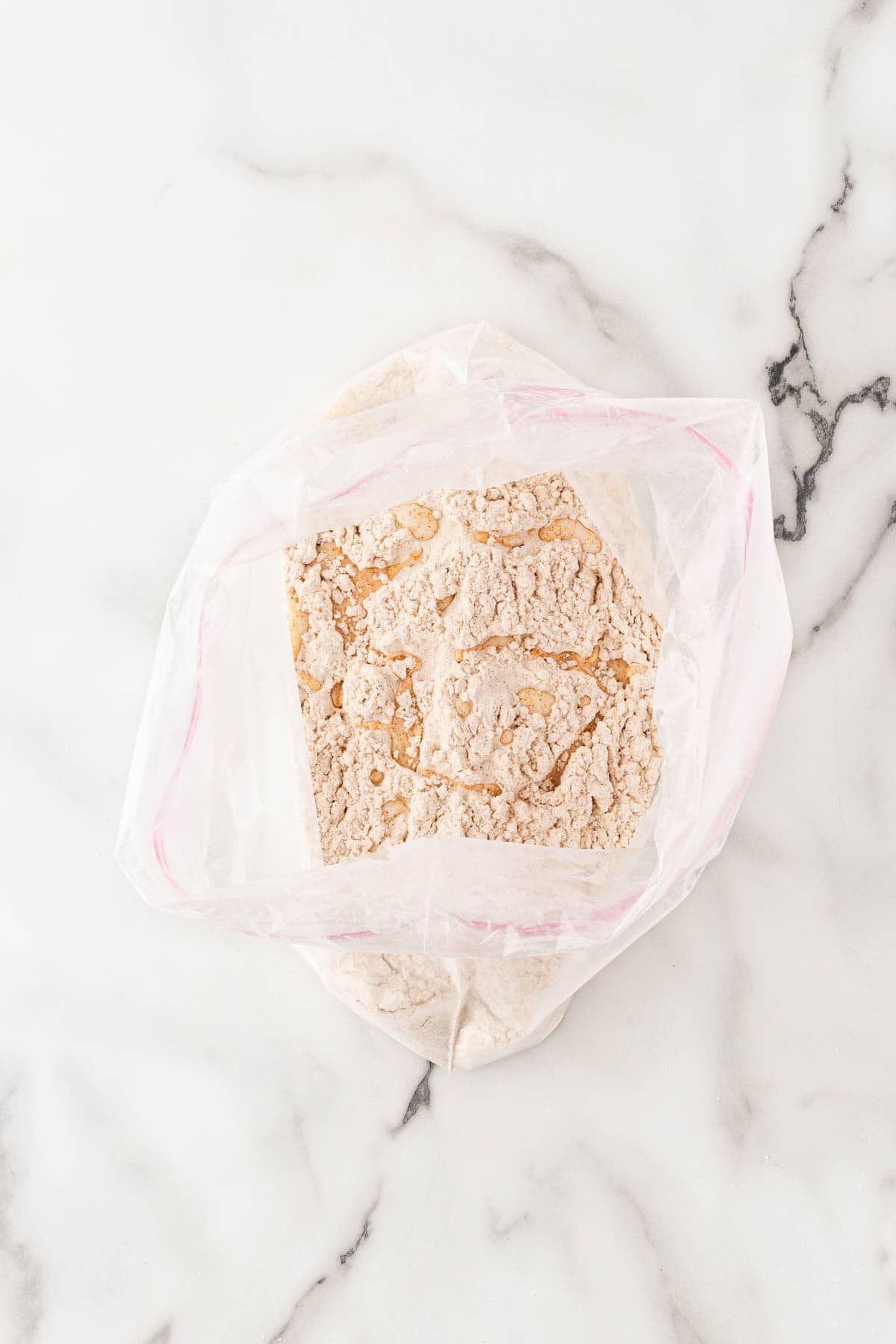 Buttermilk mixed into seasoned flour to create small crumbs