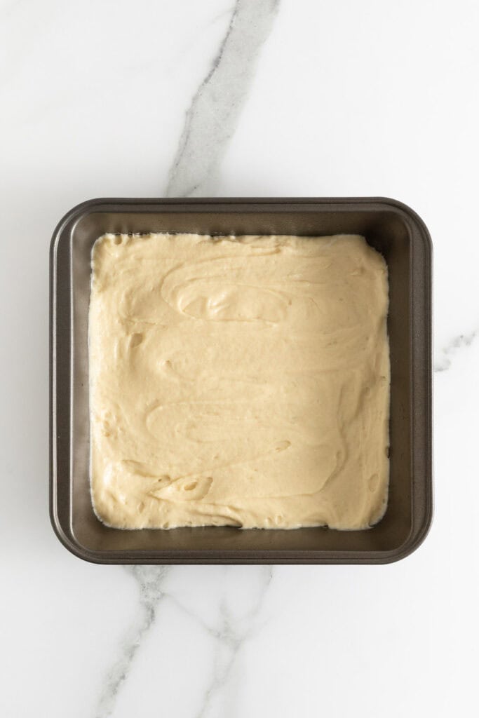 Coffee cake batter added to square baking pan