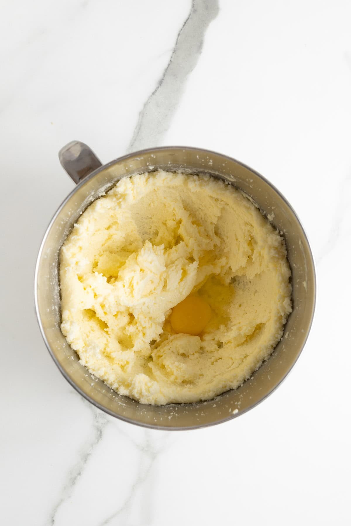 Creamed butter and sugar mixture with a raw egg in the center