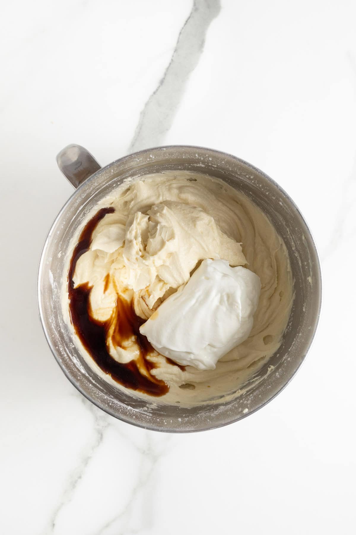 Batter with sour cream and vanilla extract added, ready to be mixed