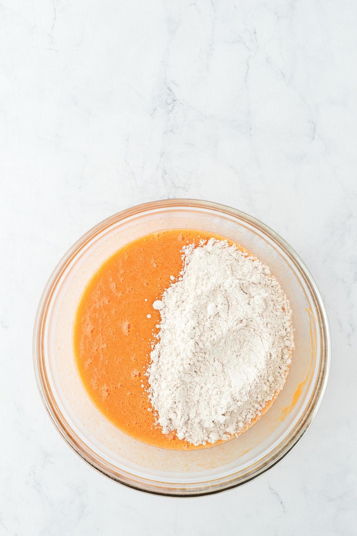 Bowl with wet ingredients and flour partially combined