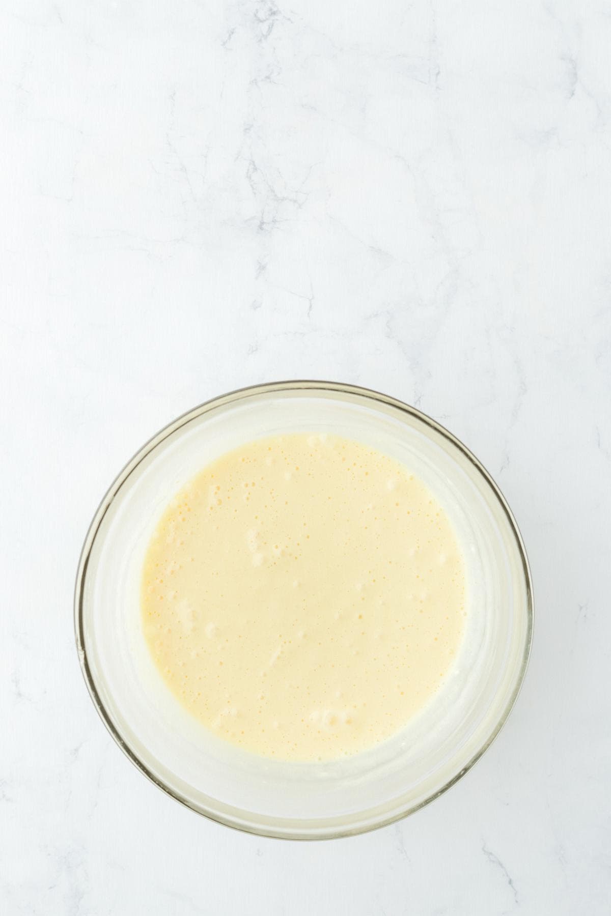 Bowl of smooth cream cheese mixture for swirling into the carrot cake batter