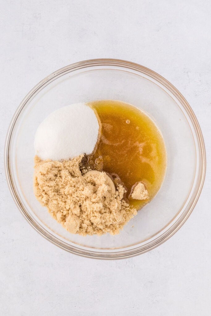 Brown butter in a bowl with granulated sugar and brown sugar