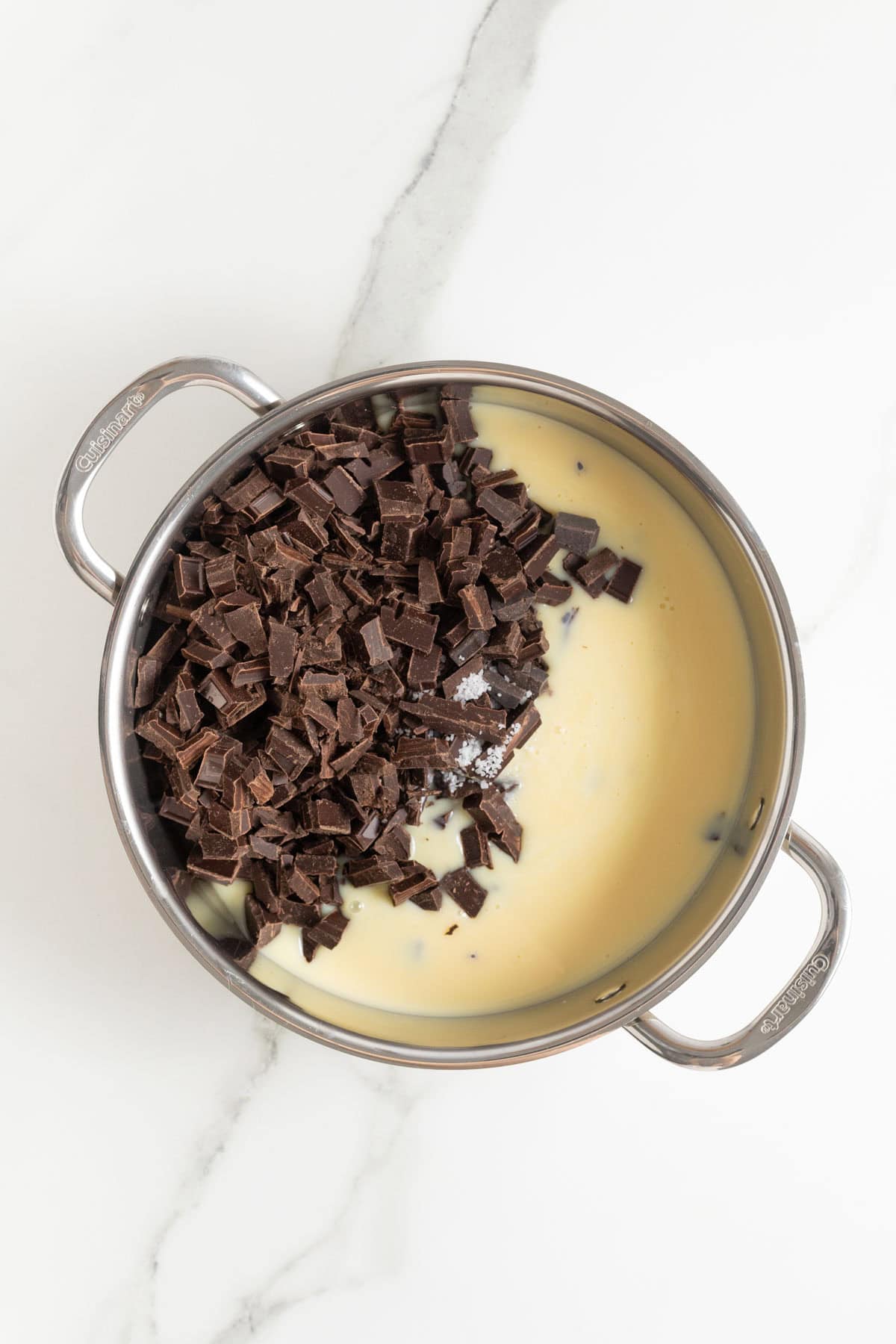 Chopped chocolate and sweetened condensed milk in a saucepan, not yet melted