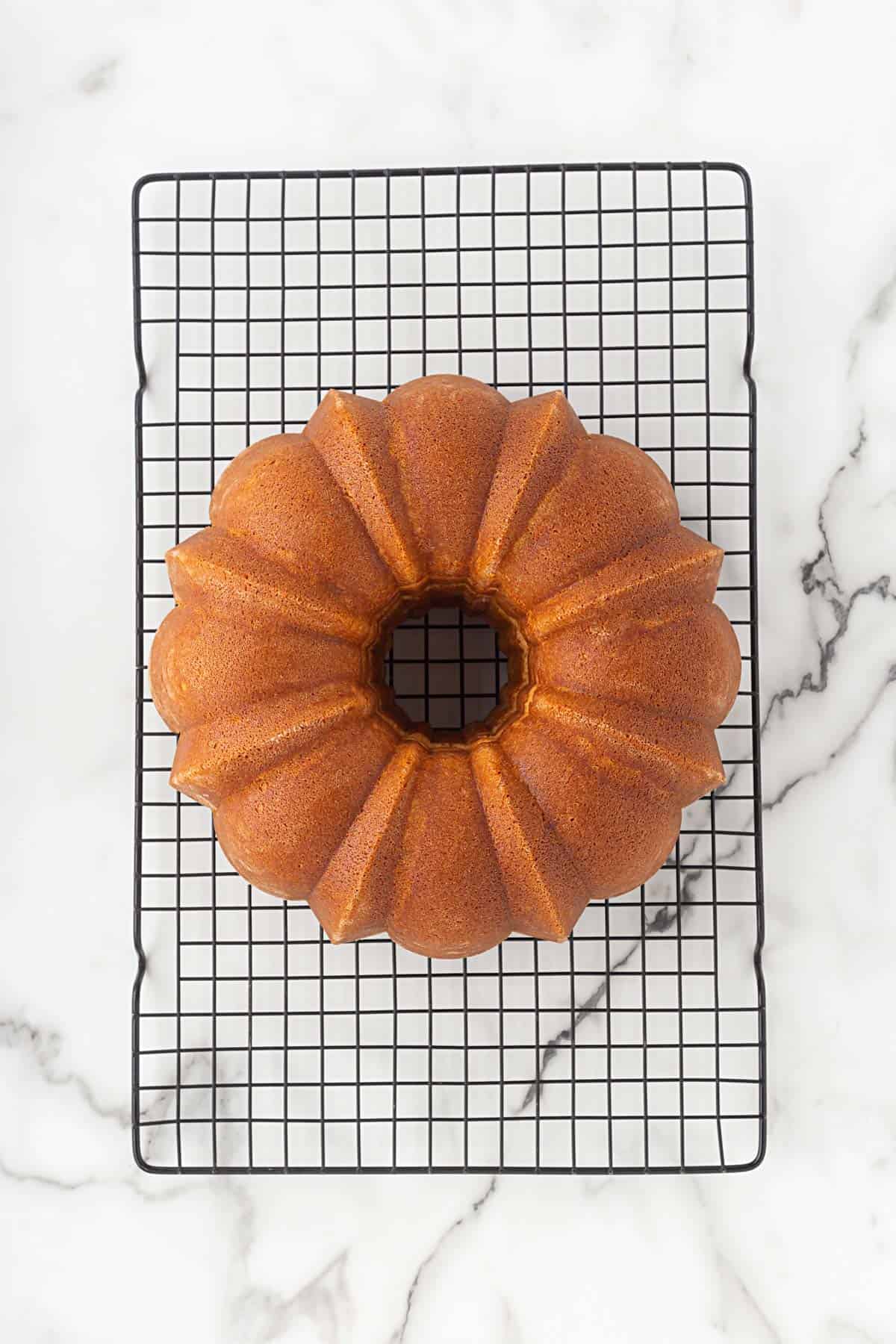 Churro pound cake cooling on a wire rack after being removed from the pan
