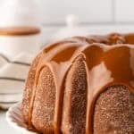 Closeup of churro pound cake covered in dulce de leche glaze dripping down the sides