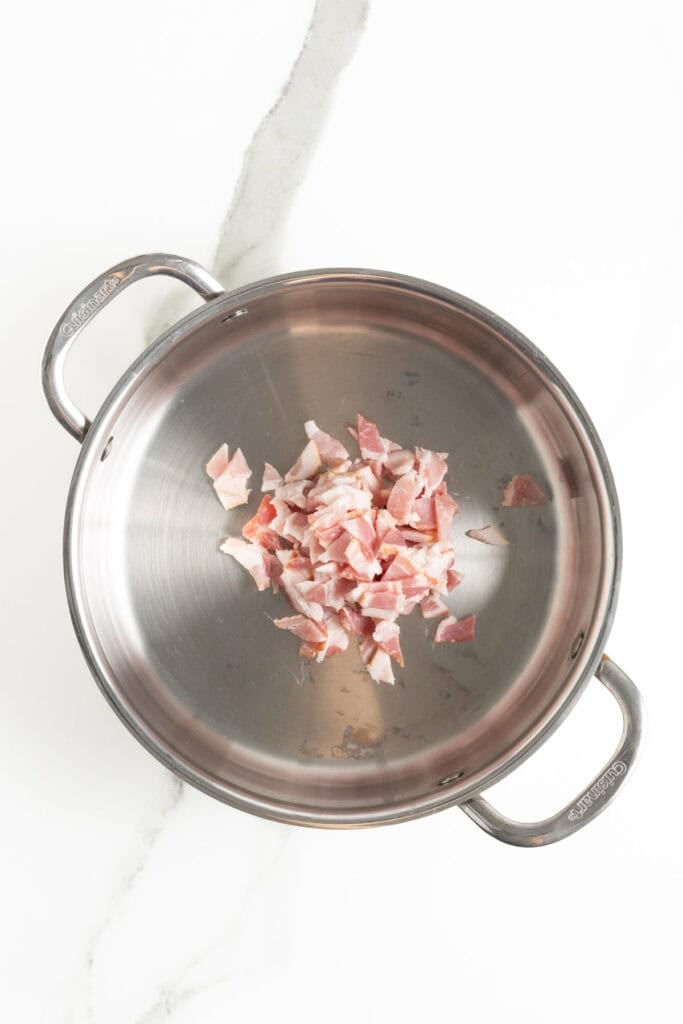 Bacon added to a skillet to cook