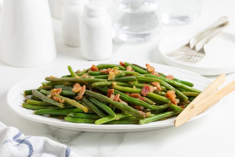 A large platter of green beans with bacon ready to serve
