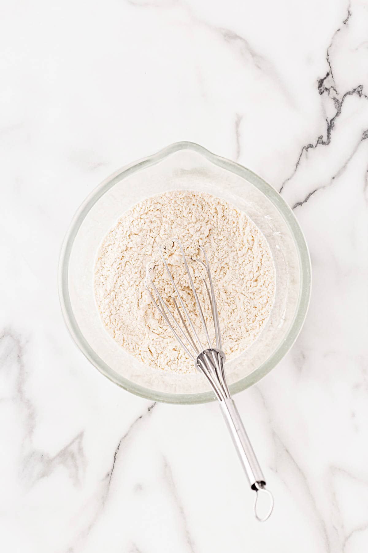 Mixing bowl with dry ingredients and a whisk