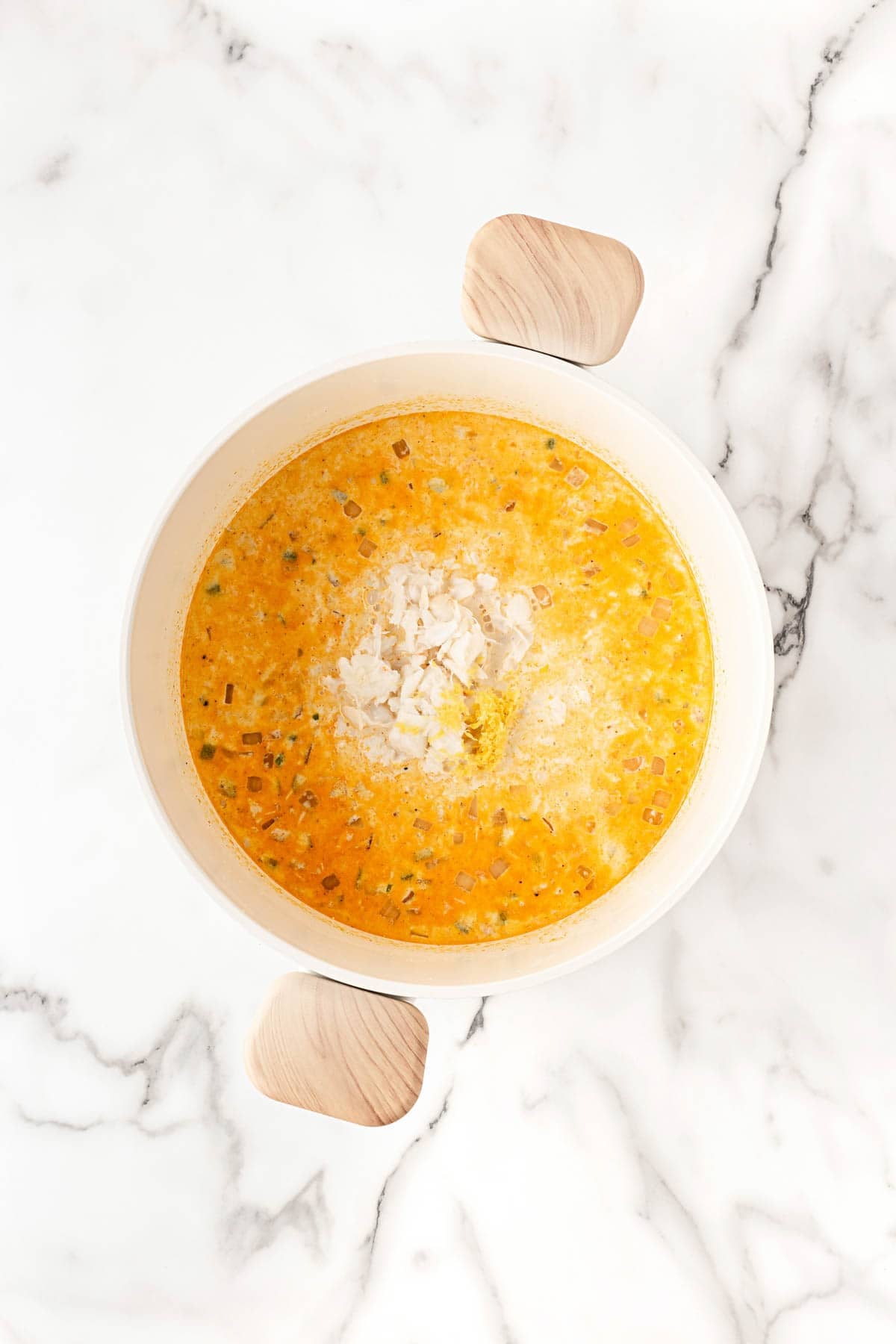 Crab meat and seasoning added to the creamy soup mixture