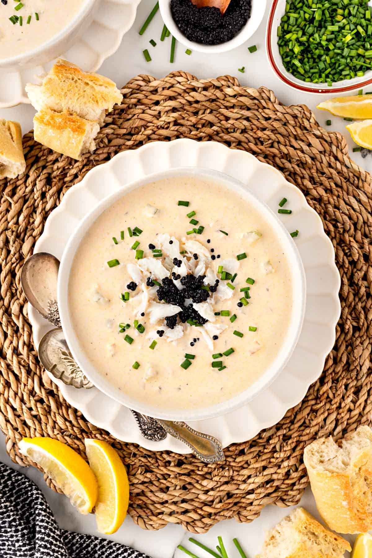 Overhead shot of she crab soup topped with crab meat and black caviar