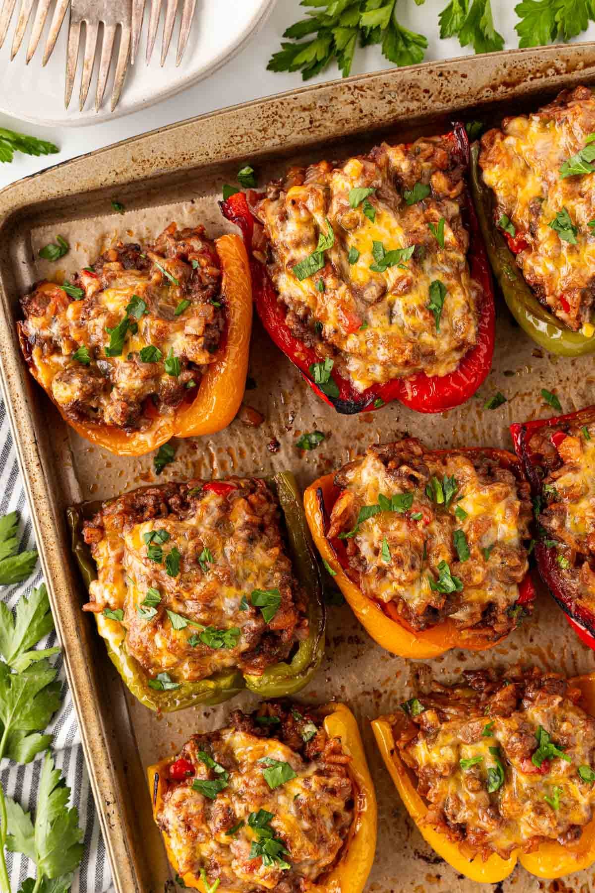 Overhead shot of cheesy baked stuffed peppers with beef filling