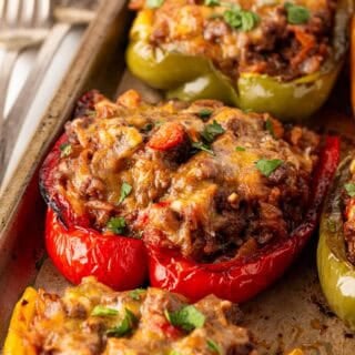 Closeup of baked stuffed peppers garnished with fresh parsley