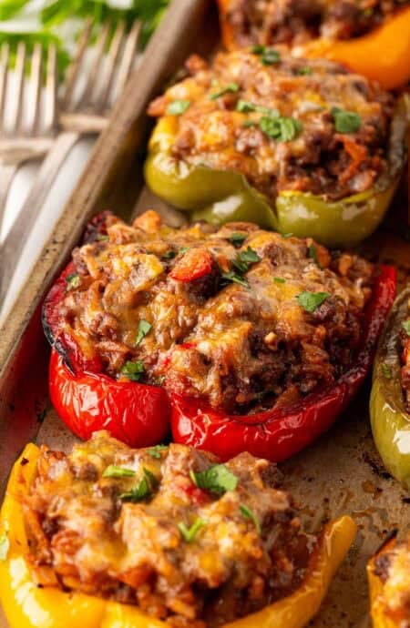 Closeup of baked stuffed peppers garnished with fresh parsley