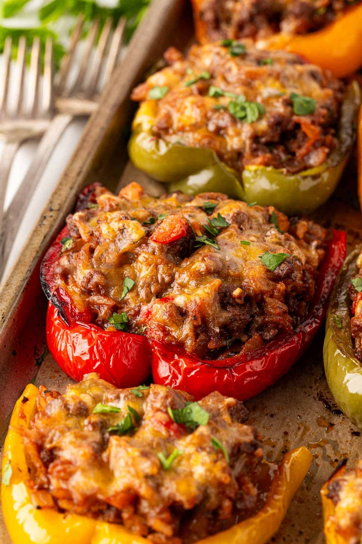 Closeup of baked stuffed peppers garnished with fresh parsley