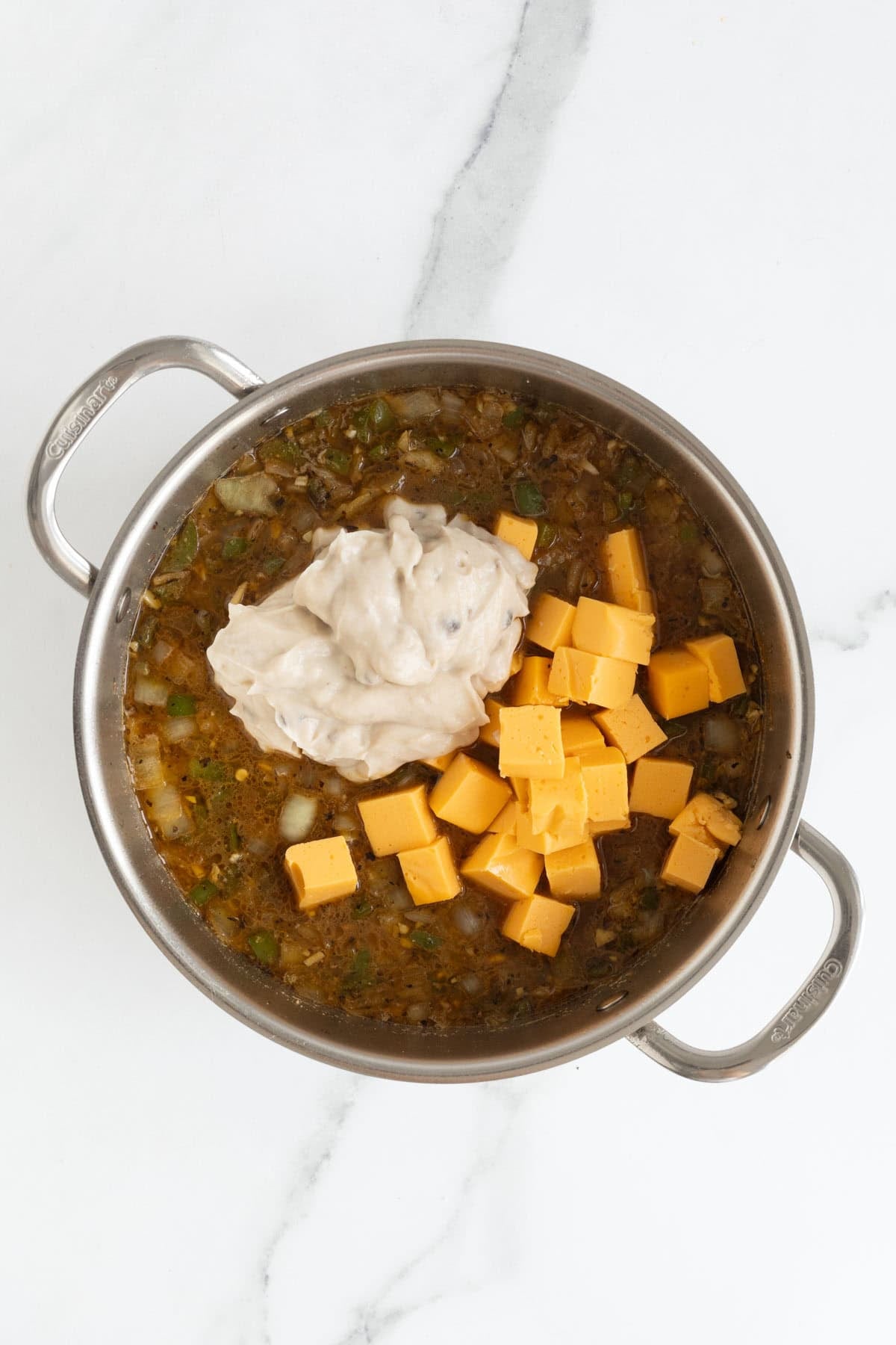 Cubed cheese and cream added to the vegetable and broth mixture