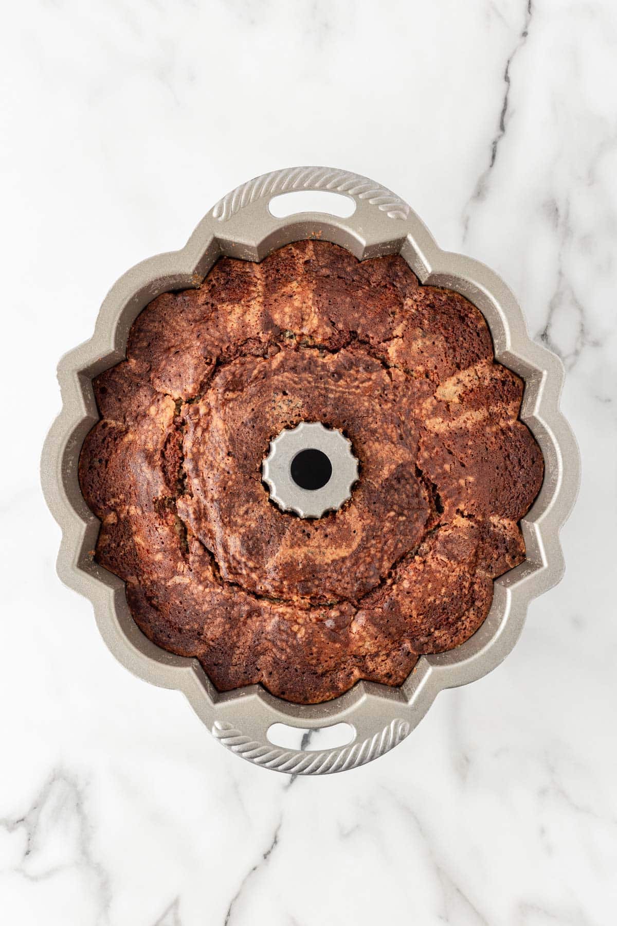 Baked Oreo pound cake with a marbled pattern inside a Bundt pan