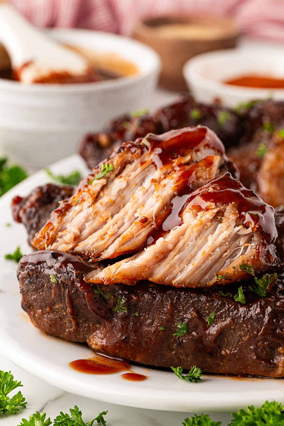 Closeup of a sliced country style pork rib showing the tender, juicy interior with barbecue sauce