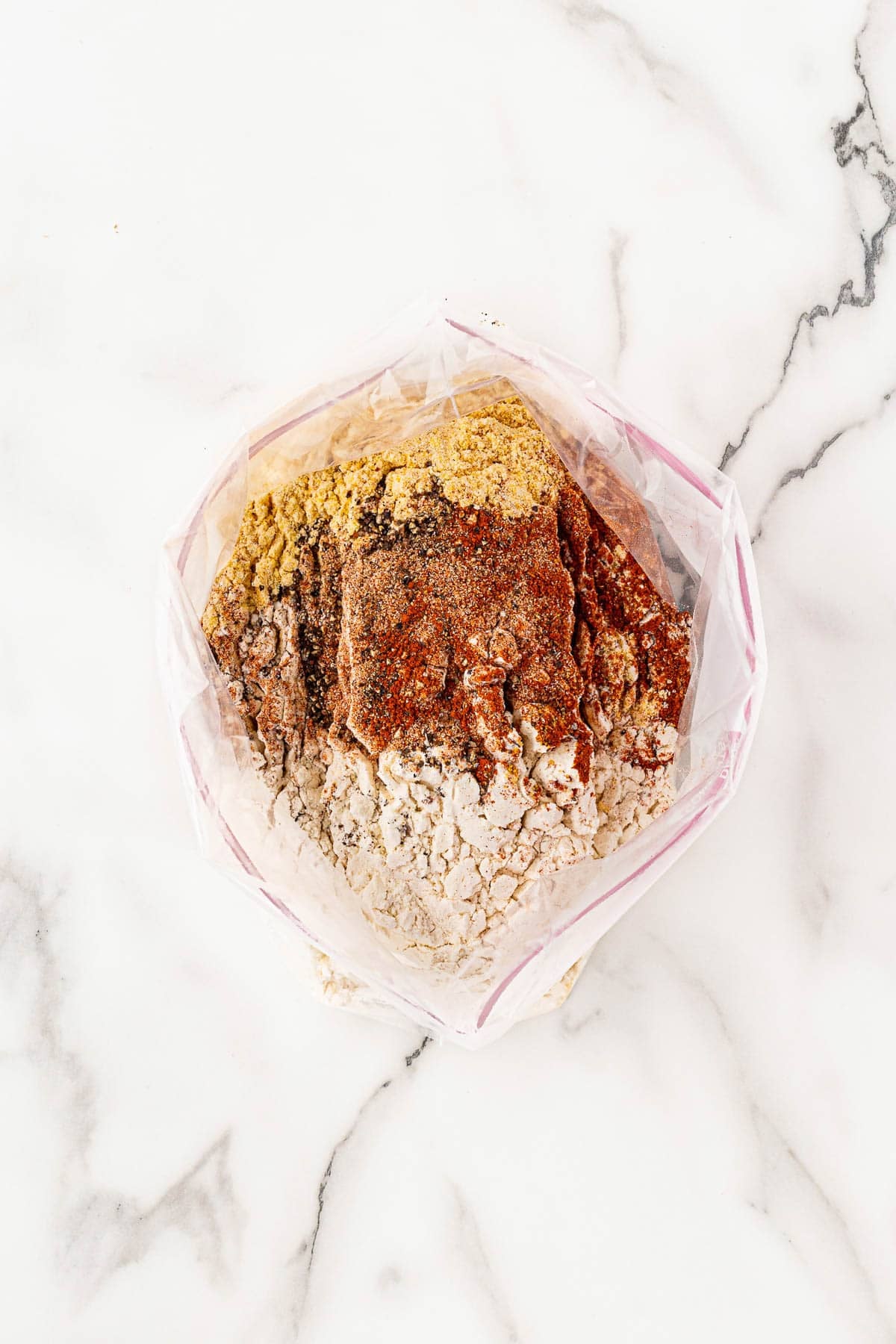 Flour and seasoning mixture in a plastic bag for dredging fish fillets