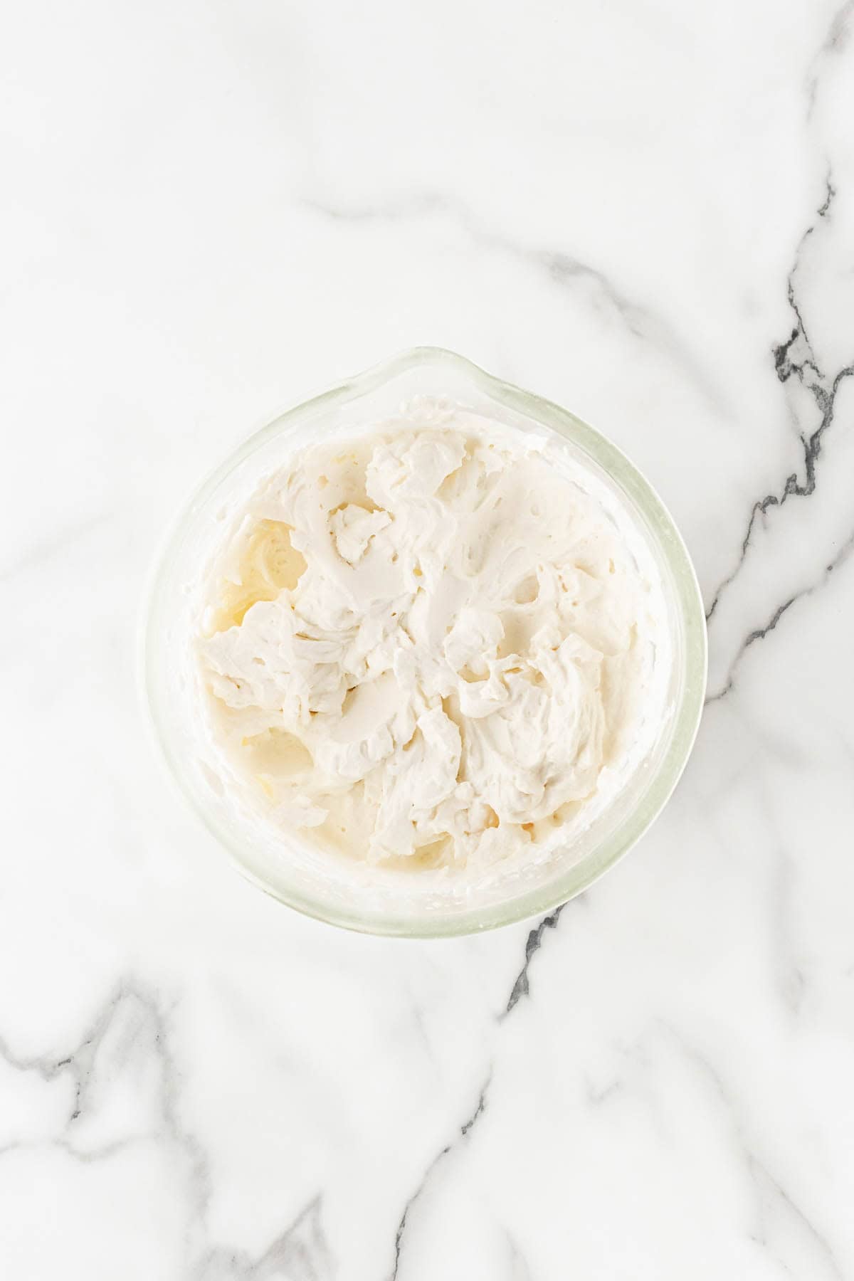 Whipped cream whipped to soft peaks in a bowl