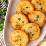 Platter of golden grit cakes garnished with parsley