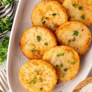 Platter of golden grit cakes garnished with parsley