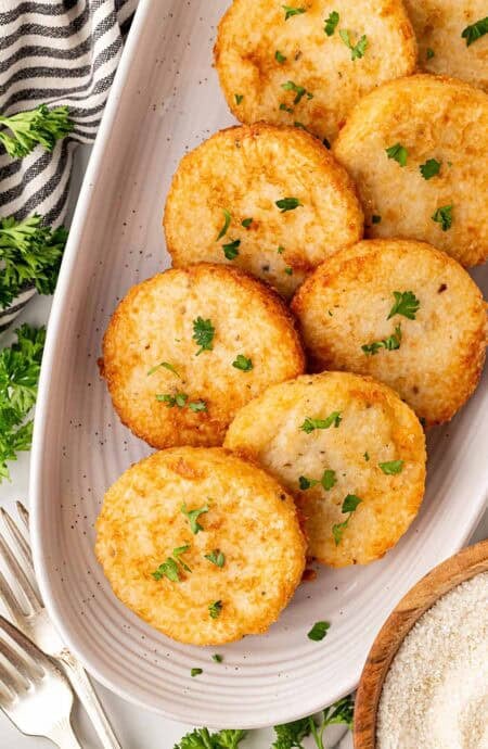 Platter of golden grit cakes garnished with parsley