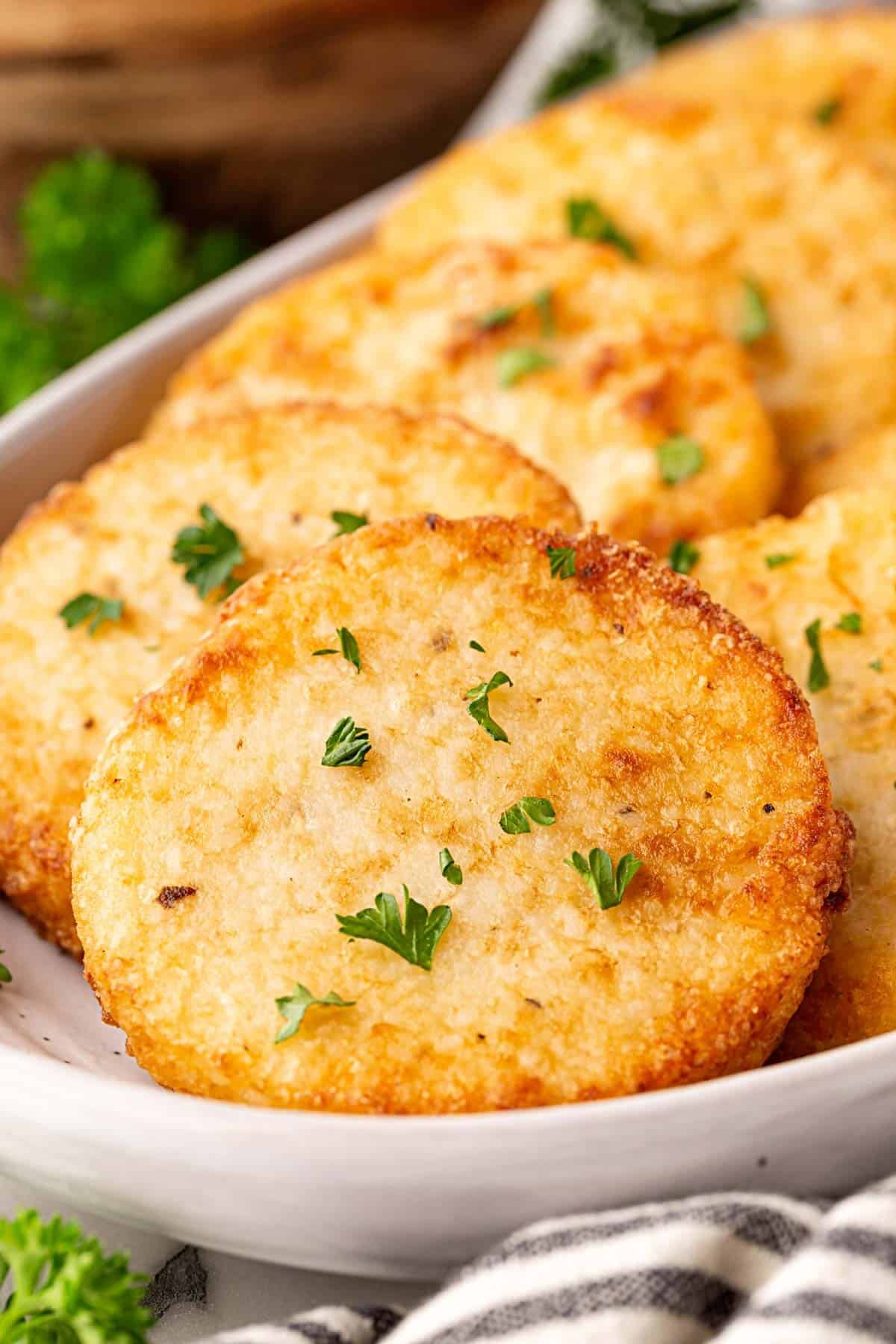 Closeup of crispy grit cakes showing golden crust and texture