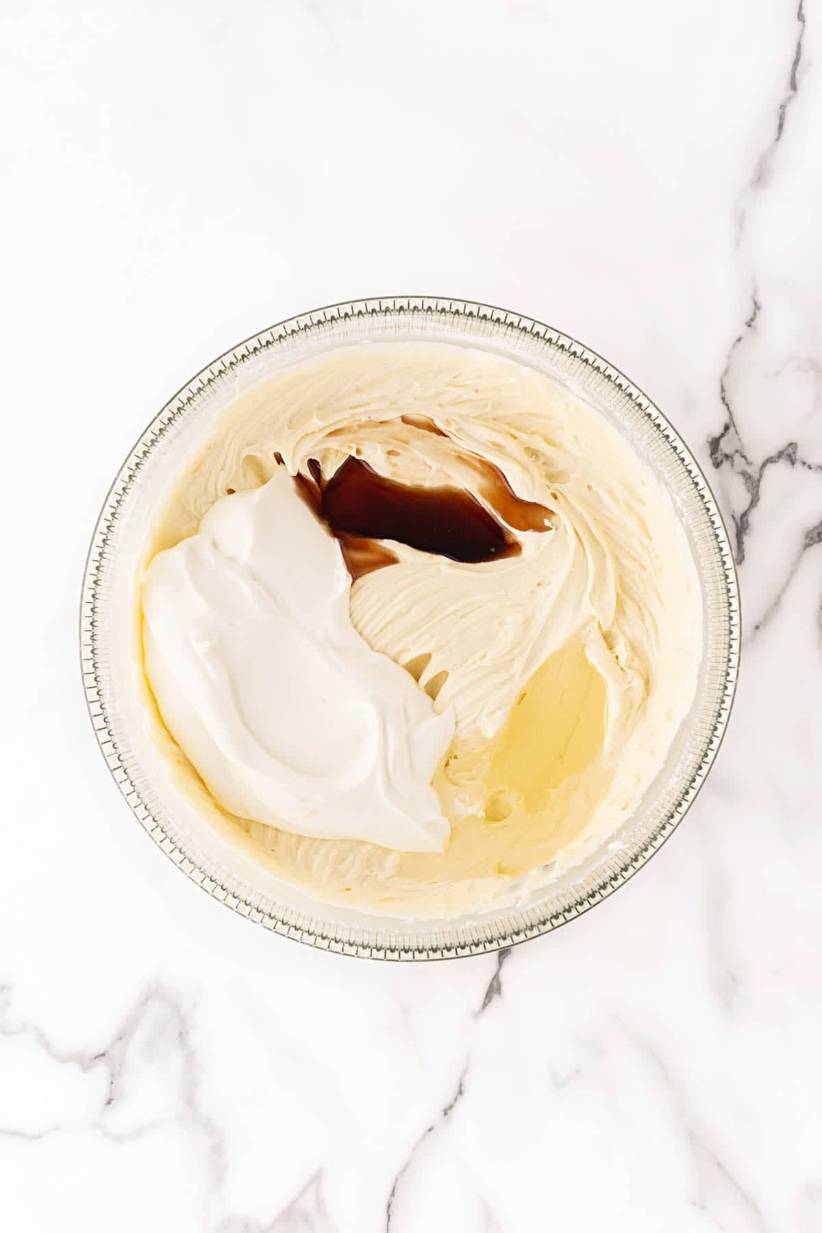 Pound cake batter with sour cream, butter, and vanilla extract added to the bowl