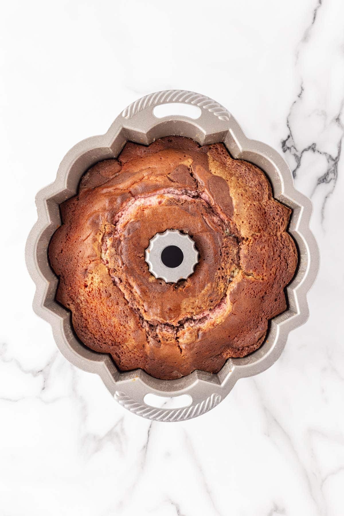 Baked Neapolitan pound cake cooling in a Bundt pan