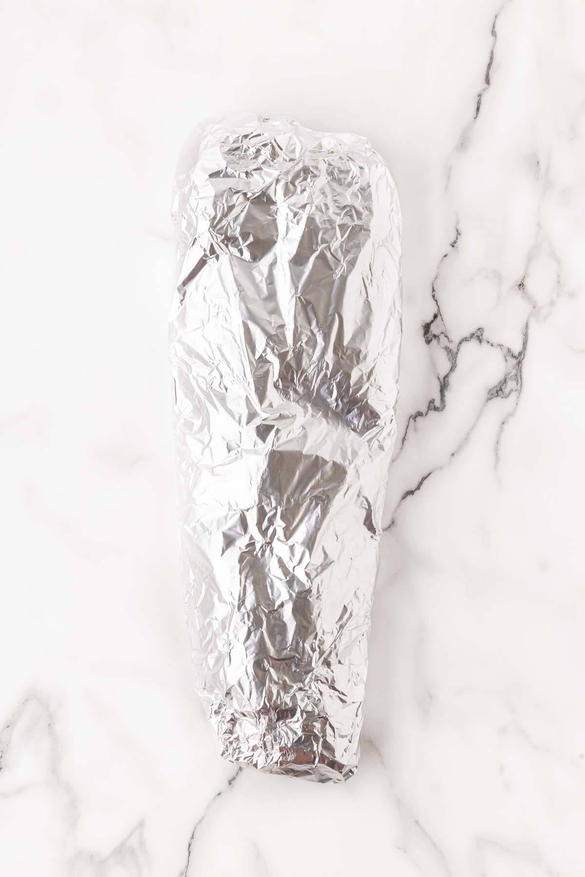 Seasoned pork ribs tightly wrapped in aluminum foil