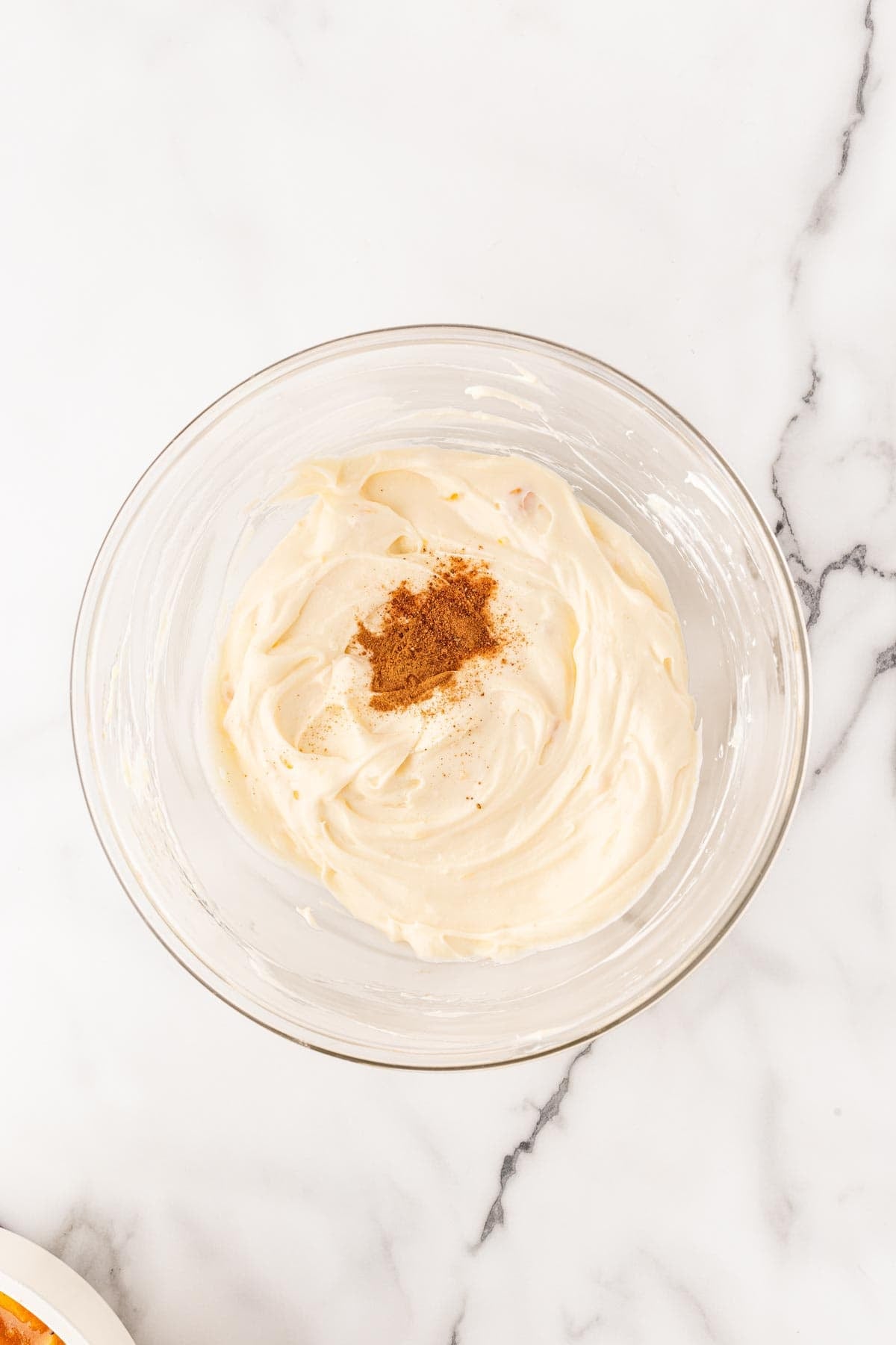 Creamy peach filling topped with cinnamon and nutmeg in glass bowl
