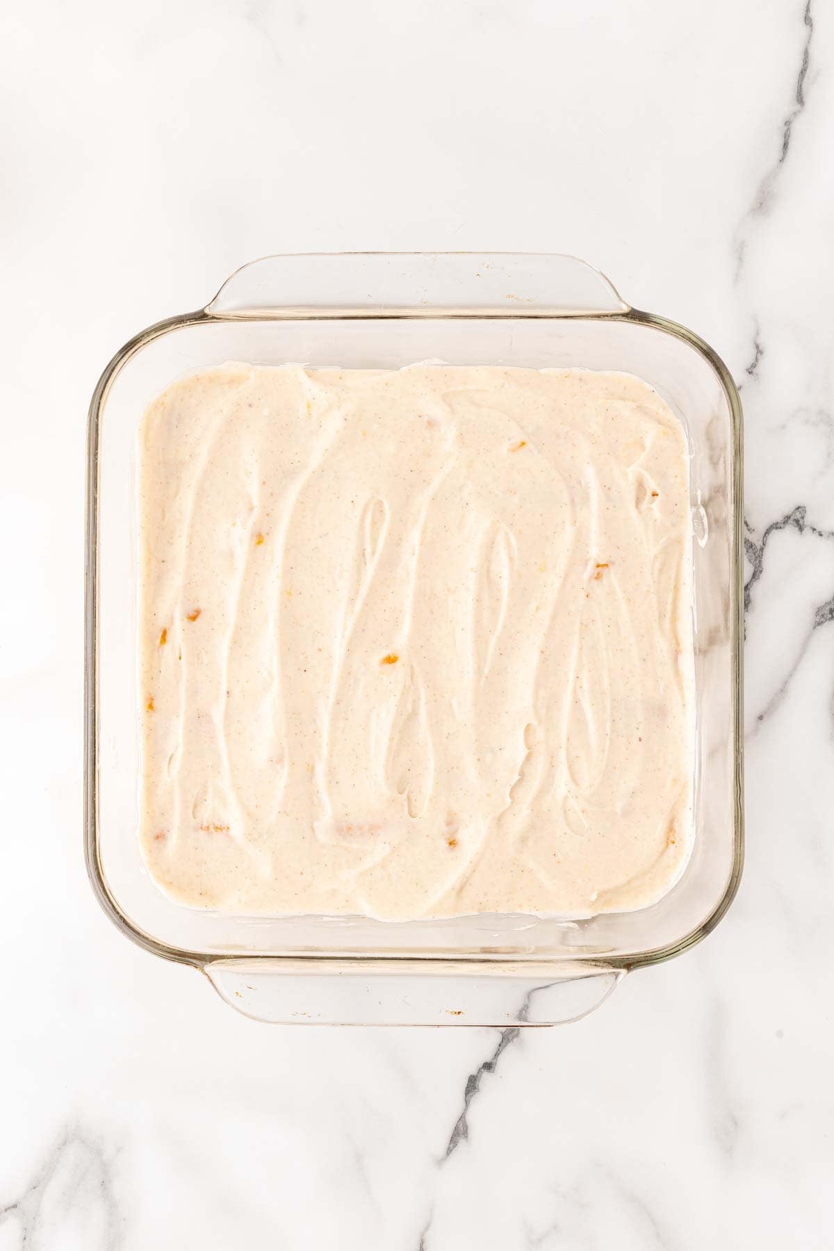 Cream filling spread evenly over ladyfinger layer