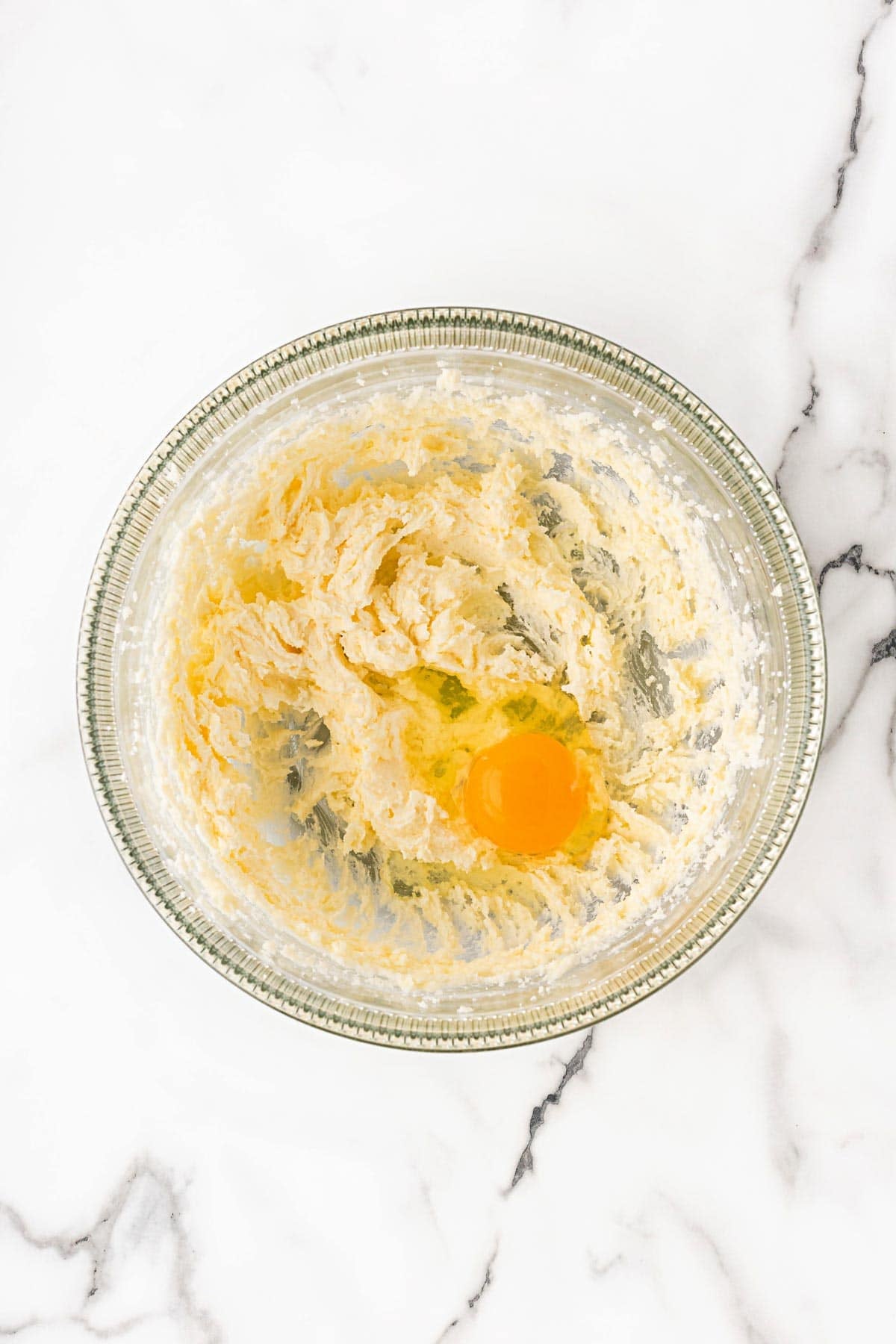 Creamed butter and sugar with egg added in mixing bowl