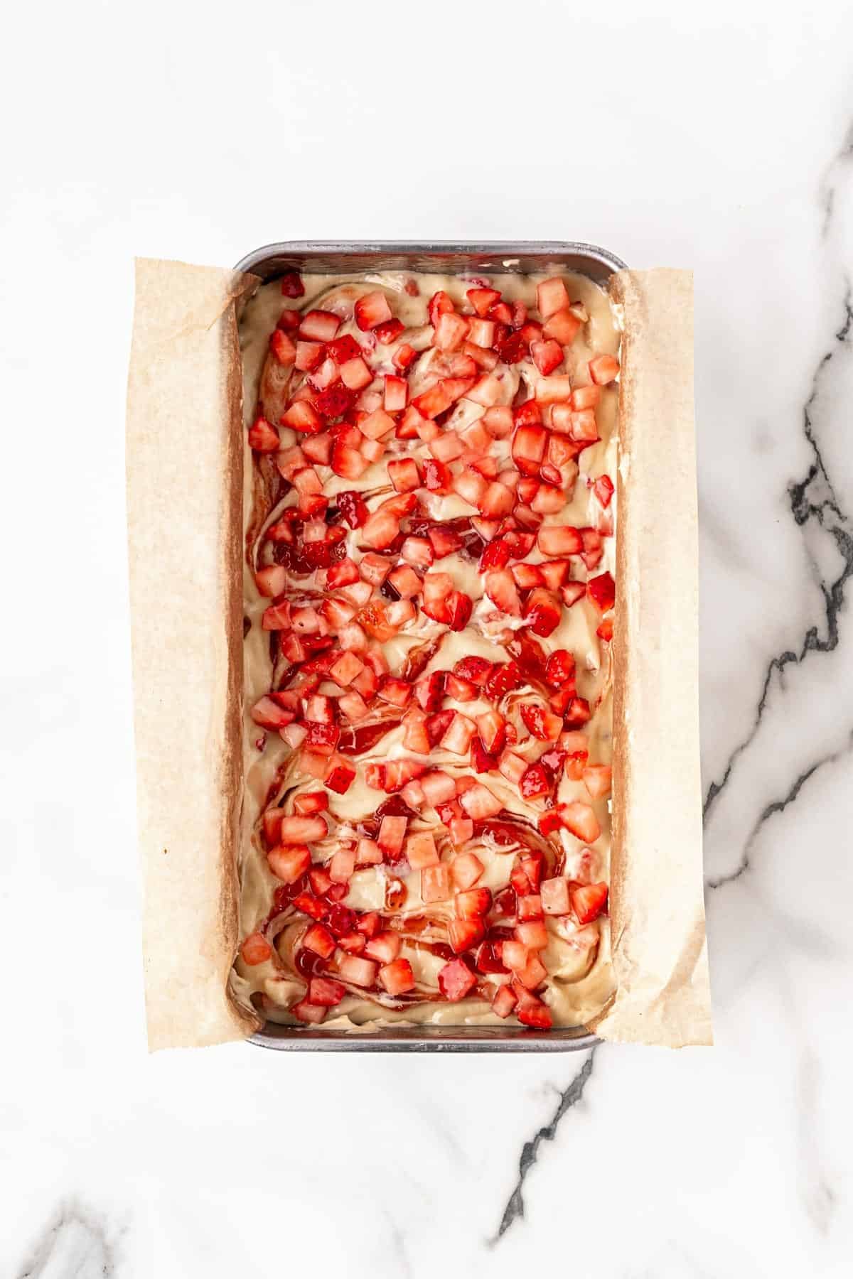 Extra chopped strawberries sprinkled over batter