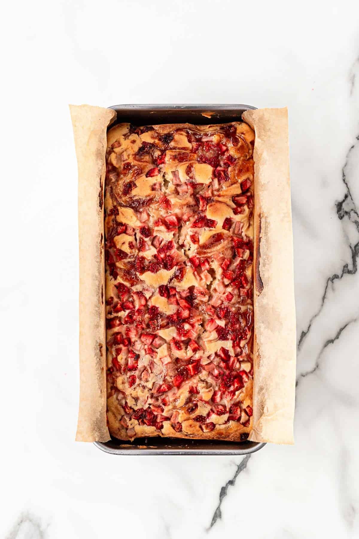 Baked strawberry bread loaf cooling in pan