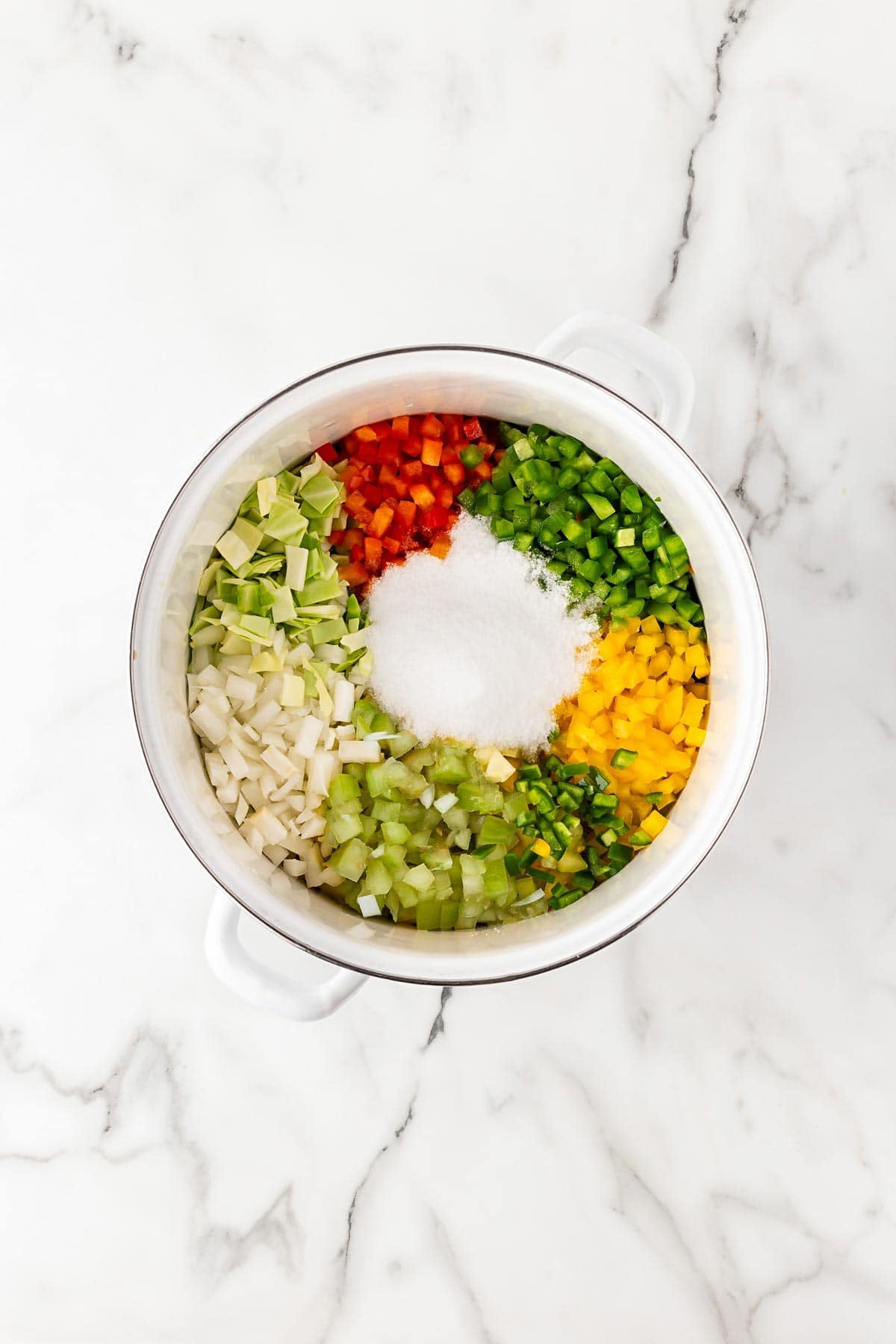 Chopped vegetables and pickling salt combined in a large bowl
